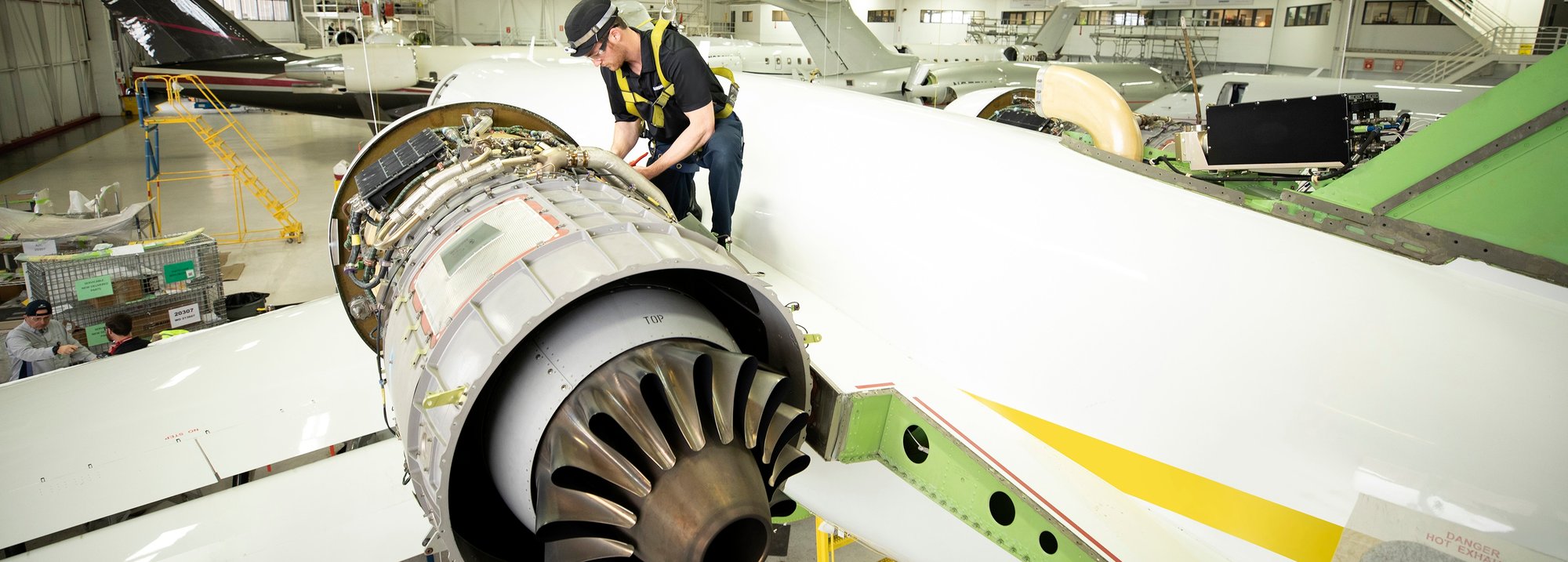 CX Maintenance Inspection Tech Standing on Top of Engine-1 CX Maintenance Inspection Tech Standing on Top of Engine-1